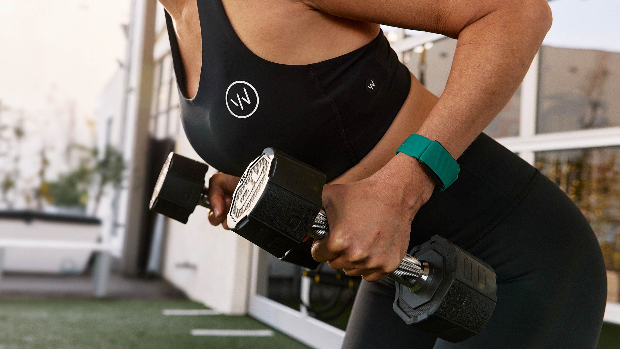 Woman wearing the WHOOP 5.0 fitness tracker band on wrist